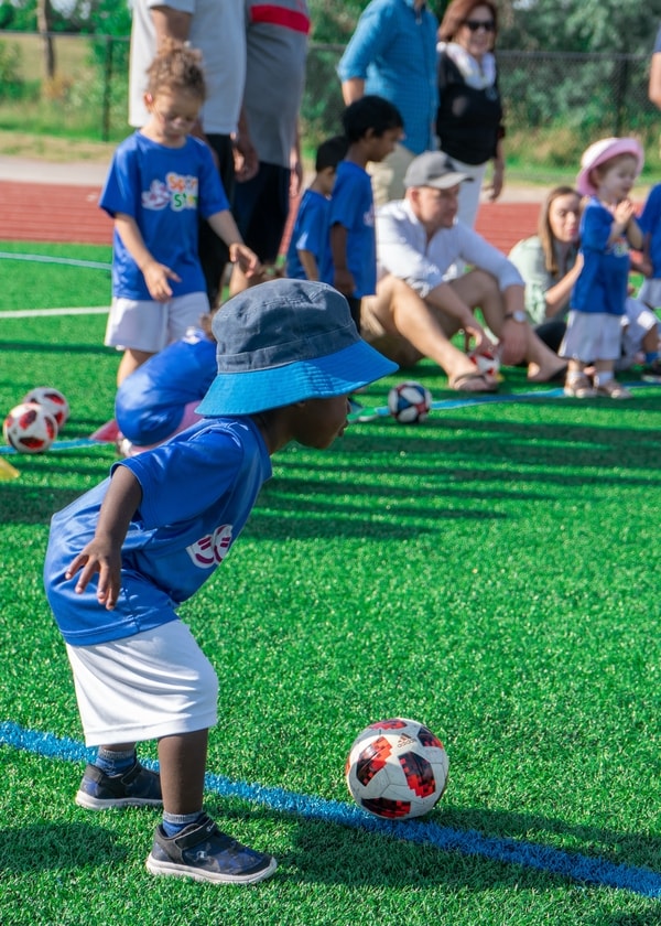 A toddler soccer player warming up